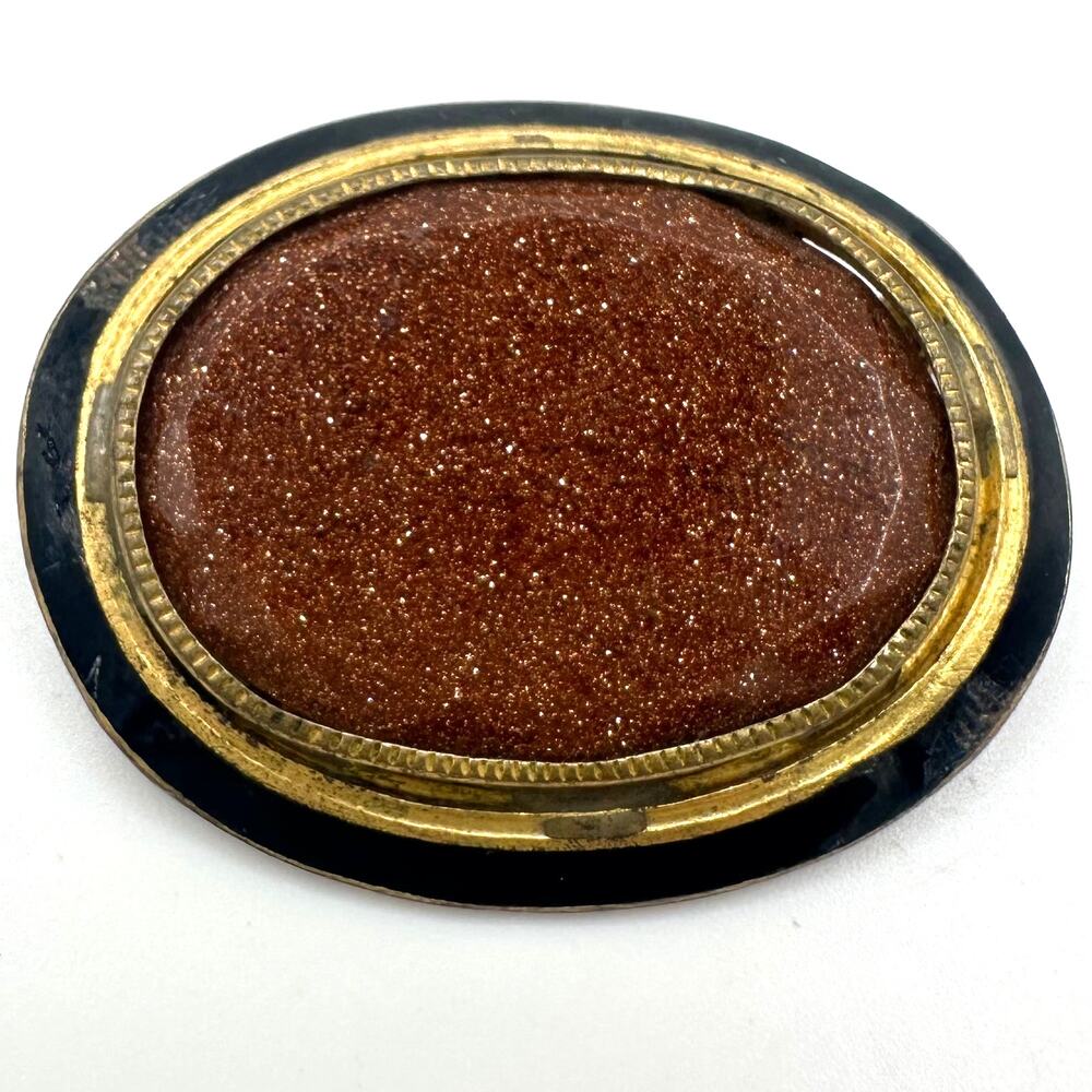 Antique 1900s 1910s gold gilt brown glitter sunstone black enamel oval brooch